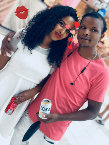 a man in a pink shirt holding a can of loka