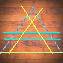 the letter a is made out of straws on a wooden floor