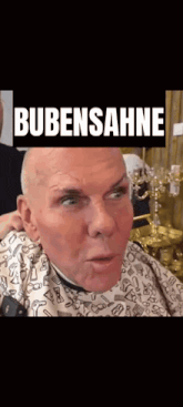 a bald man is getting his hair cut by a barber and the words bubensahne are above him .
