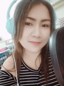 a woman wearing headphones and a striped shirt