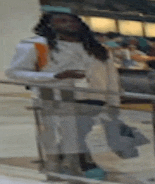 a blurry picture of a man standing next to a railing in a restaurant .