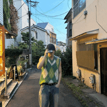 a man in a green vest is taking a picture of a street