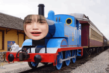 a blue train with a woman 's face on the front of it