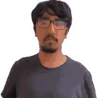 a man with glasses and a beard is looking at the camera