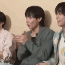 a group of people are sitting around a table talking and laughing .