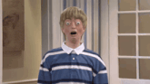 a boy in a blue and white striped shirt looks surprised