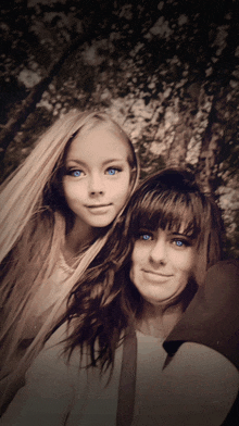 two girls with blue eyes pose for a photo