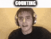 a man wearing headphones is counting .