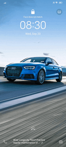 a blue audi is driving down a highway on a sunny day