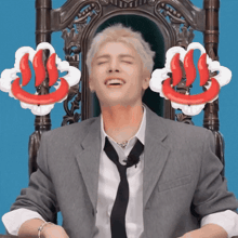 a man in a suit and tie is sitting in a chair with his eyes closed and a red and white smiley face behind him