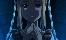 a close up of a girl with braids in a dark room with her hands folded in front of her face .