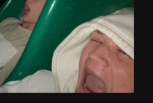 a man wearing a white hoodie is yawning