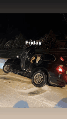 a black car is parked in the snow with the door open and the words friday below it