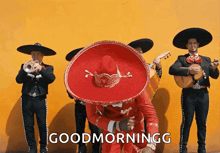 a group of mariachi players are standing in front of a yellow wall with the words good morninggg written on the bottom