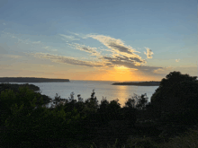 the sun is setting over a large body of water
