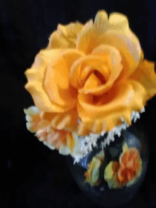 a close up of a yellow flower in a vase