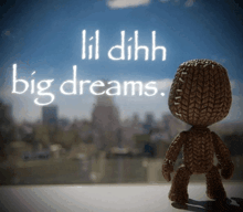 a knitted doll is standing in front of a window with the words lil dihh big dreams