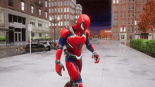 a man in a spiderman costume walks down a street in front of harlem neighborhood center