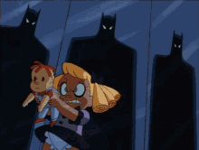 a girl in a purple dress is holding a child in front of a wall with batman shadows behind her