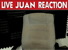 a chair sits under a live juan reaction sign