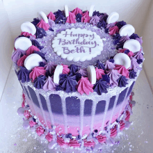 a pink and purple birthday cake with the words happy birthday beth written on it