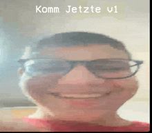 a pixelated image of a man wearing glasses and smiling with the words komm jetzte v1 below him