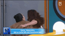 a woman hugging another woman with the words gala finalista de la casa de los famosos mx