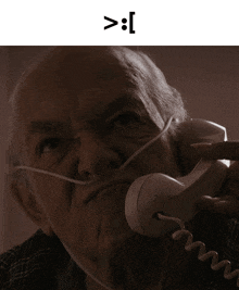 an elderly man wearing an oxygen mask is talking on a phone