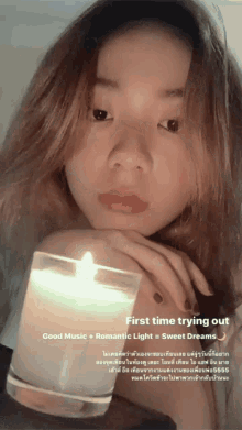 a woman holding a candle with the words first time trying out at the top