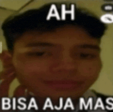 a close up of a man 's face with the words `` ah bisa aja mas '' written above him .