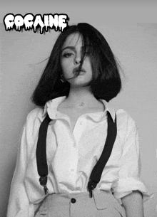 a woman wearing suspenders and a white shirt has the word cocaine on the bottom