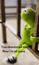 a kermit the frog sitting on a railing with the words you abandoned me now i 'm all alone