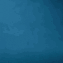 a silhouette of a robot in the water with a blue background