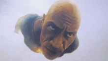 a bald man is flying through the air and looking up at the camera .