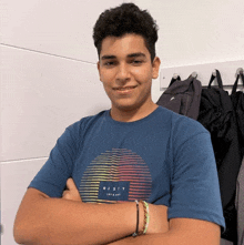 a young man wearing a blue shirt with the word rusty on it