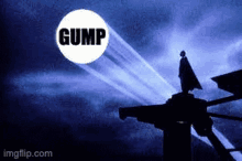 a silhouette of a man standing on top of a building in front of a blue sky with a gump logo .