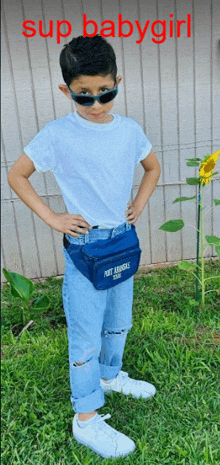 a boy wearing sunglasses and a fanny pack that says port aransas on it