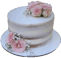 a naked cake with pink roses and baby 's breath on top of it