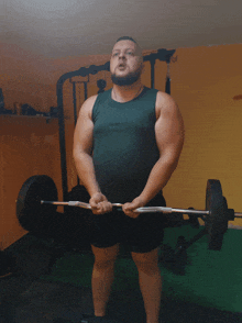 a man lifting a barbell in a gym