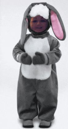 a child dressed in a bunny costume with gloves