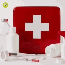 a red first aid kit with a white cross on the front