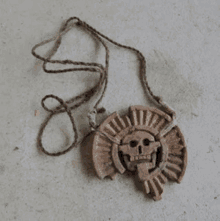 a necklace with a skull pendant on a string