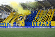 a soccer stadium with a banner that says ' aelapa ' on it