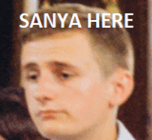 a close up of a man 's face with the words sanya here below him