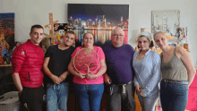 a group of people standing in front of a painting