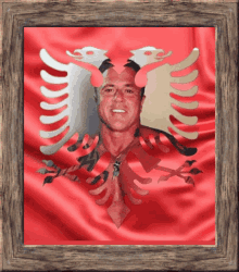 a picture of a man in front of an eagle on a red background in a wooden frame