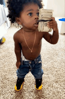 a little boy is holding a pile of money in his mouth .