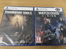 two ps5 games tormented souls and watch dogs legion are on a wooden table