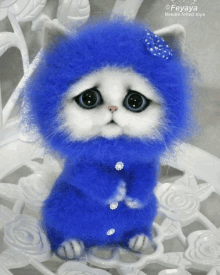 a blue and white stuffed animal with needle felted toys written on it