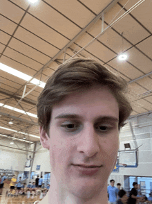 a young man taking a selfie in a gym